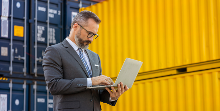 Supply chain manager working on a tablet, using it to manage and control operations in a smart and efficient way.