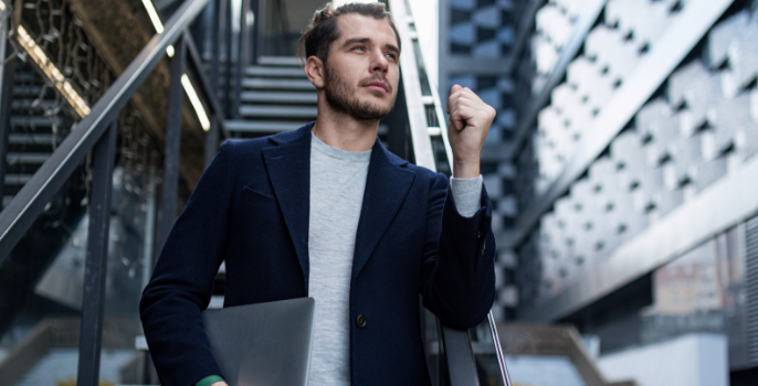 A young entrepreneur, looking towards the future, is confident in his software, which was designed to be scalable and reliable, in order to manage the growing volume of data, user traffic, and business demands within the supply chain.