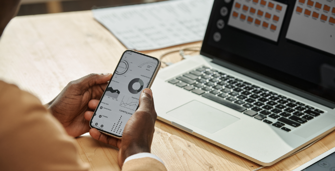 The hands of a supply chain business owner using Grydd Sphere, the collaboration platform, accessing a digital control center where all aspects of their supply chain are seamlessly integrated, creating a harmonious system that optimizes efficiency and facilitates decision-making.