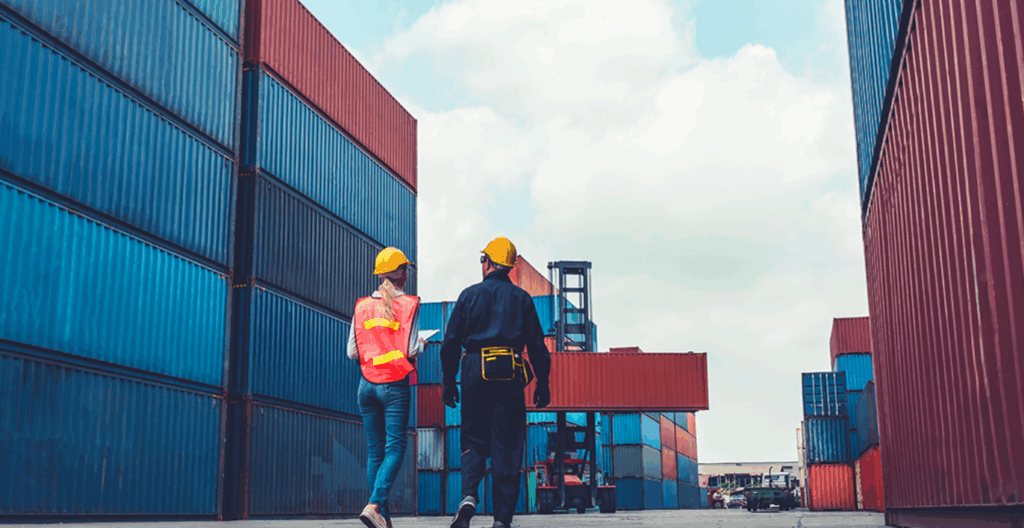 Supply chain logistics agents walk through a container yard.